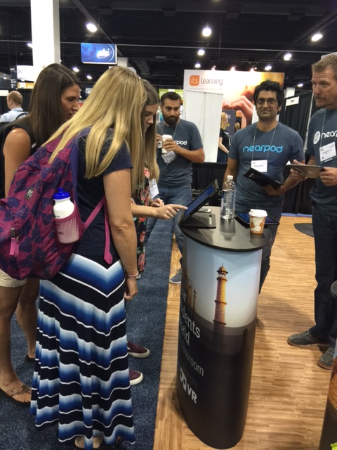 Teachers crowded around a booth