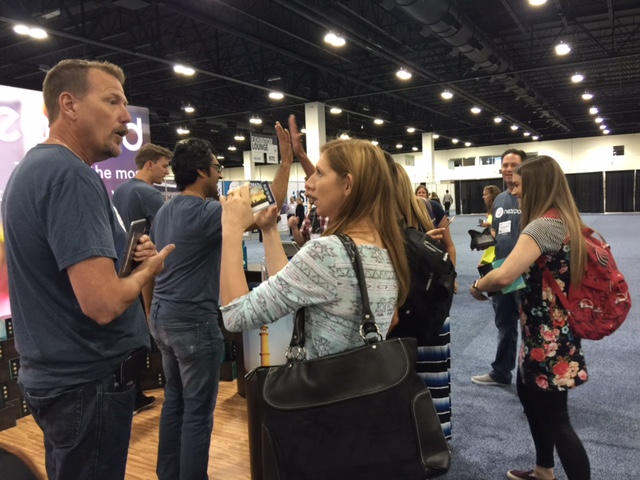 People talking at a booth